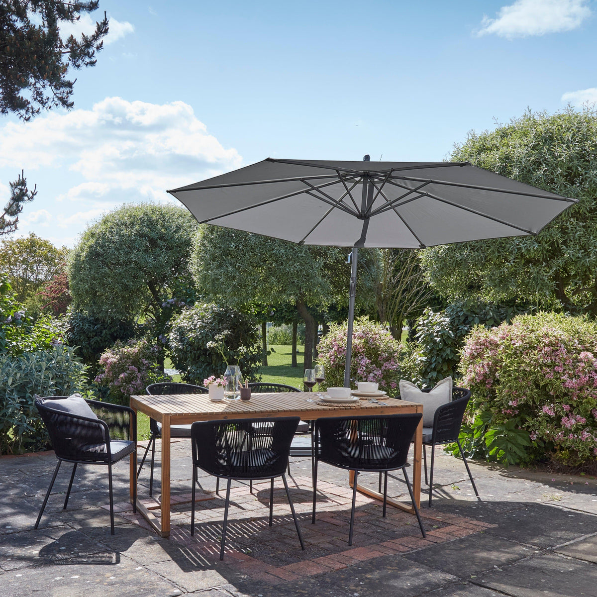 Lennox Table With 6 Hali Black Dining Chairs and Grey Lean Over Parasol