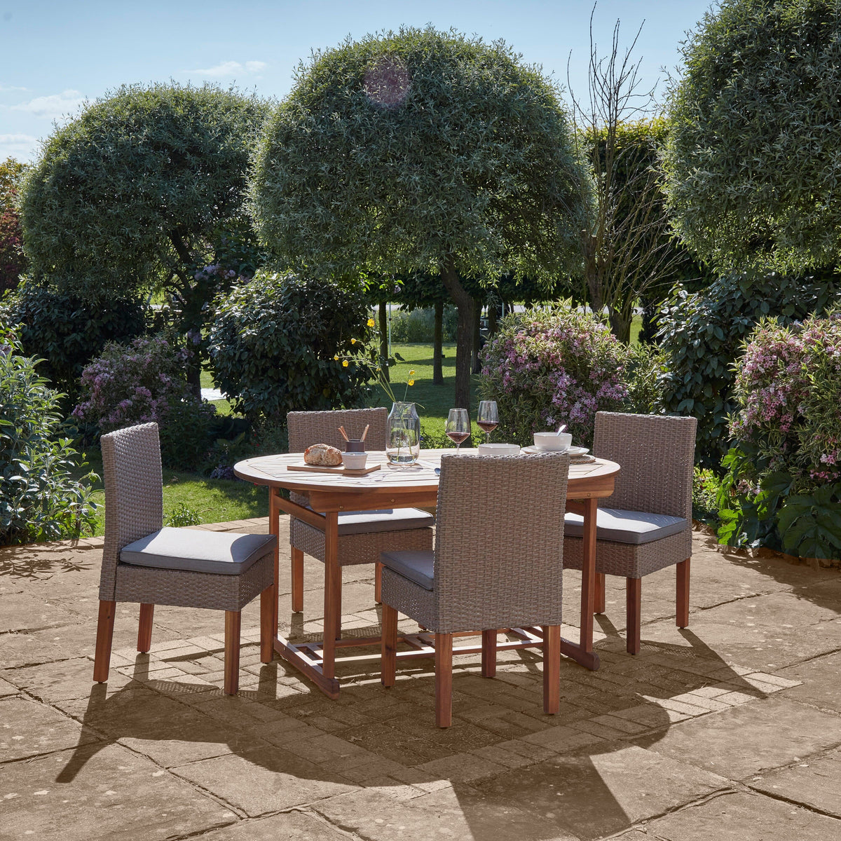 Oakley 4 Seater Wooden Extendable Round Garden Dining Table with 4 Rattan Dining Chairs - Laura James